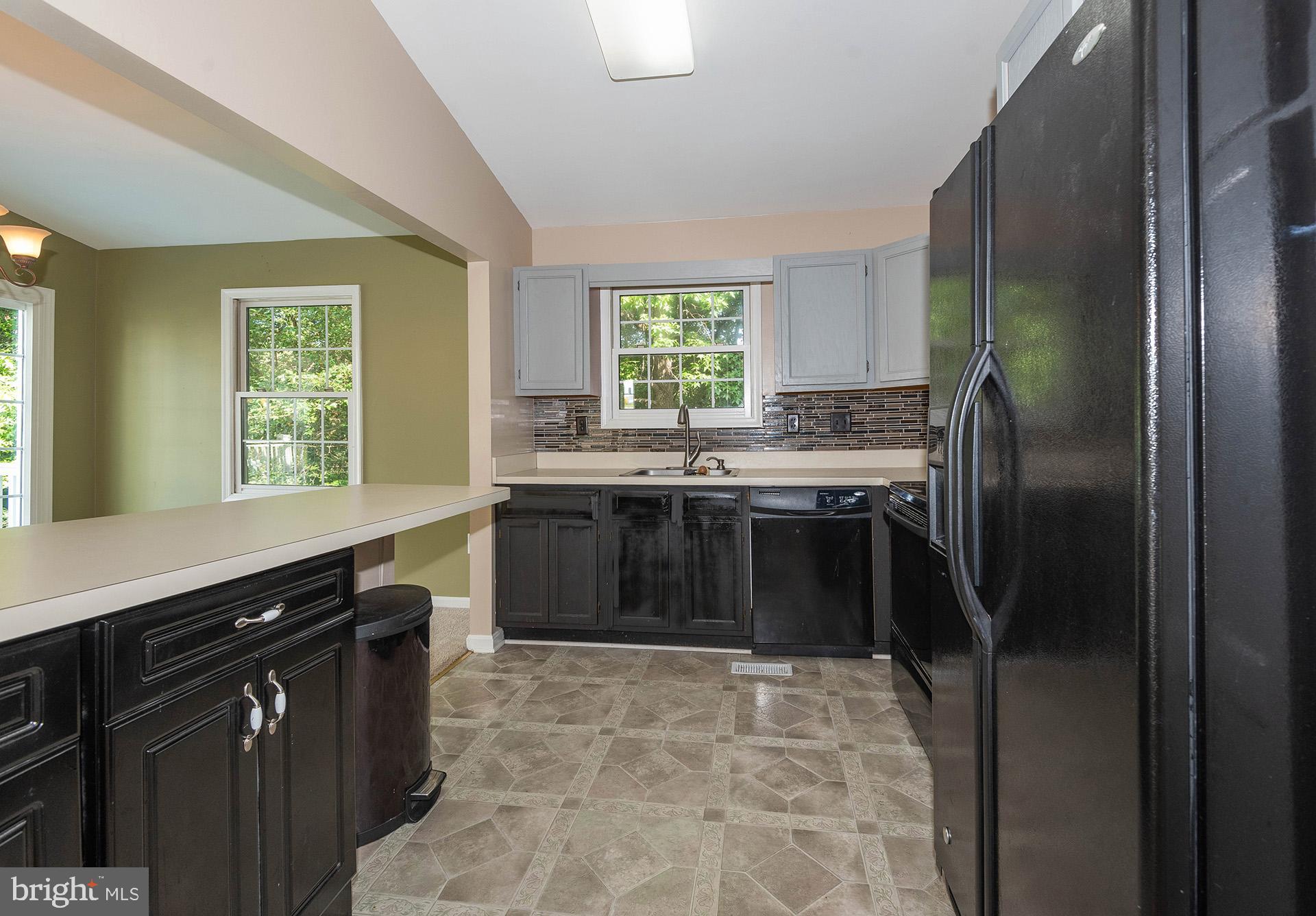 7523 Harmans Road Harmans, MD 21077 - Photo 9 of 27 a kitchen with a stove sink and refrigerator