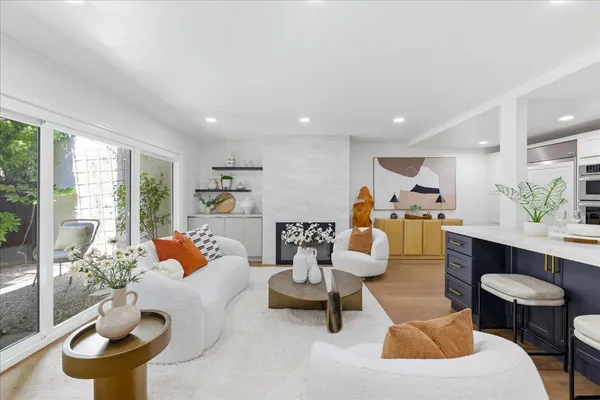 a kitchen with stainless steel appliances granite countertop a sink window and cabinets