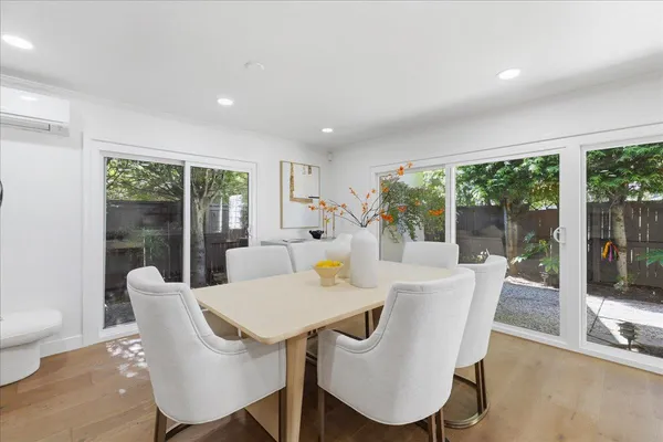 a kitchen with a table chairs sink and cabinets