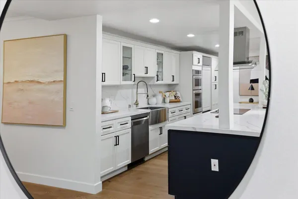 a spacious bedroom with two beds and painting on the wall
