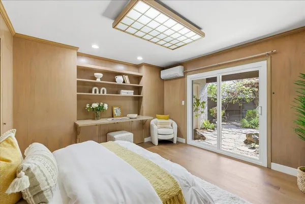 a view of a room with wooden floor and a window