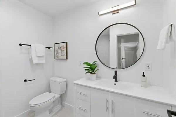 a bathroom with a double vanity sink toilet and shower