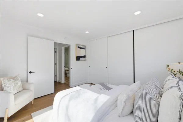 a bedroom with a bed and a potted plant