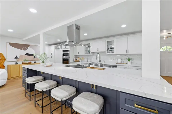 a living room with furniture kitchen view and a table