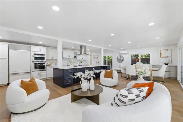 a kitchen with stainless steel appliances kitchen island granite countertop a stove a sink and a refrigerator