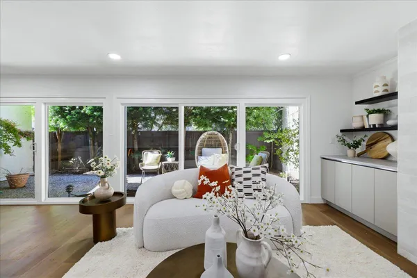 a living room with furniture and kitchen view