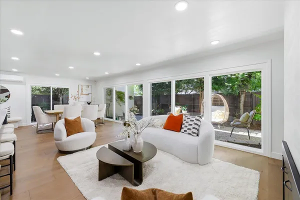 a large kitchen with stainless steel appliances a large counter top a stove and a sink