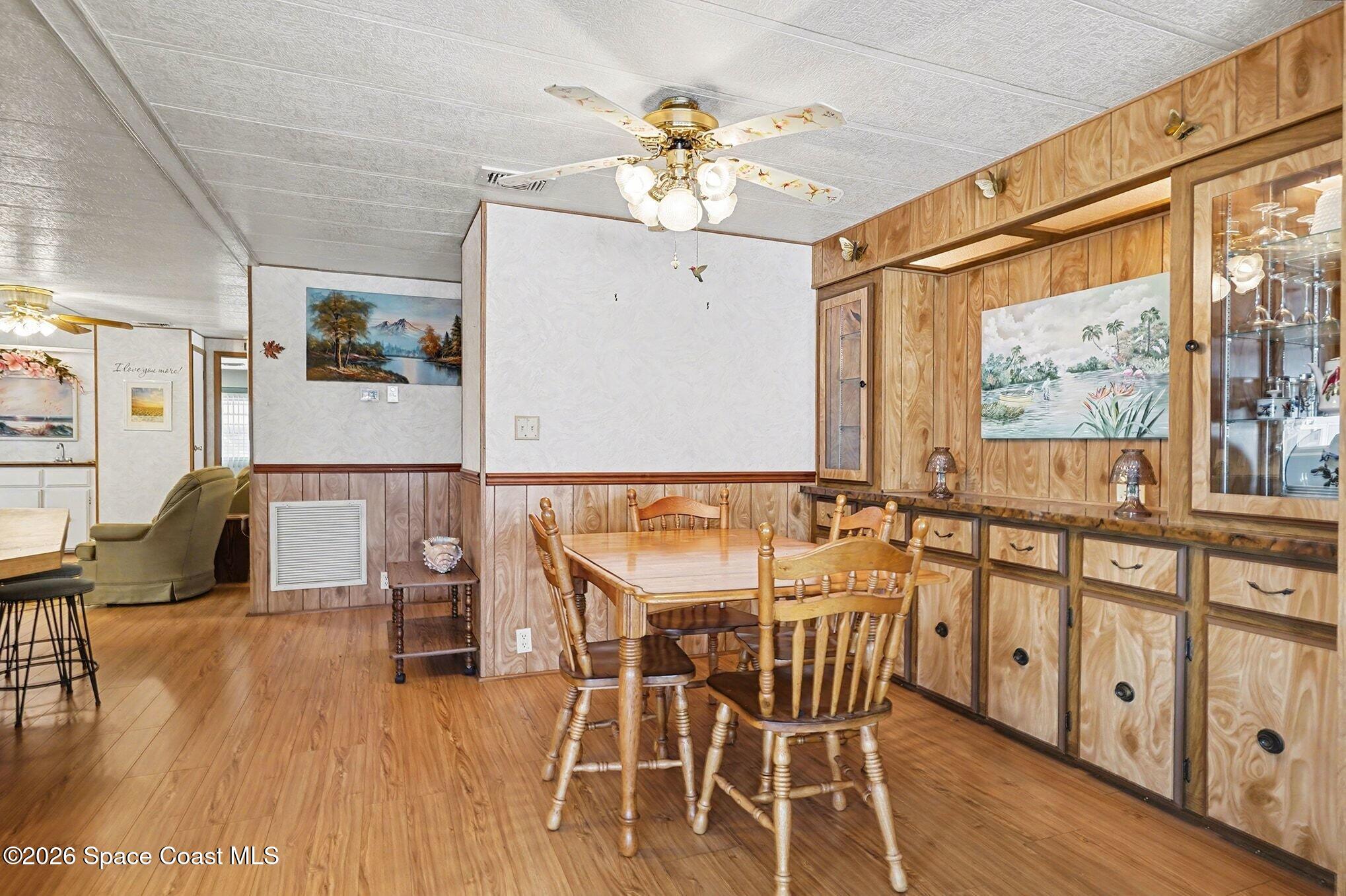 1740 Coco Plum Street Northeast Palm Bay, FL 32905 - Photo 11 of 33 a view of a dining room with furniture window and wooden floor