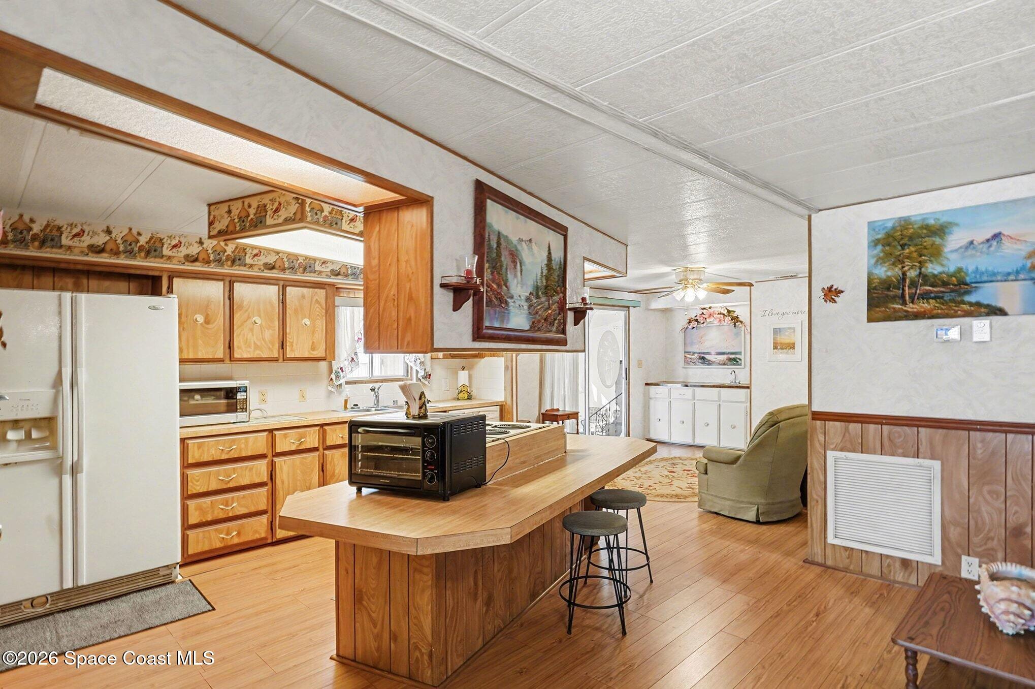 1740 Coco Plum Street Northeast Palm Bay, FL 32905 - Photo 14 of 33 a living room with stainless steel appliances furniture a couch and a kitchen view