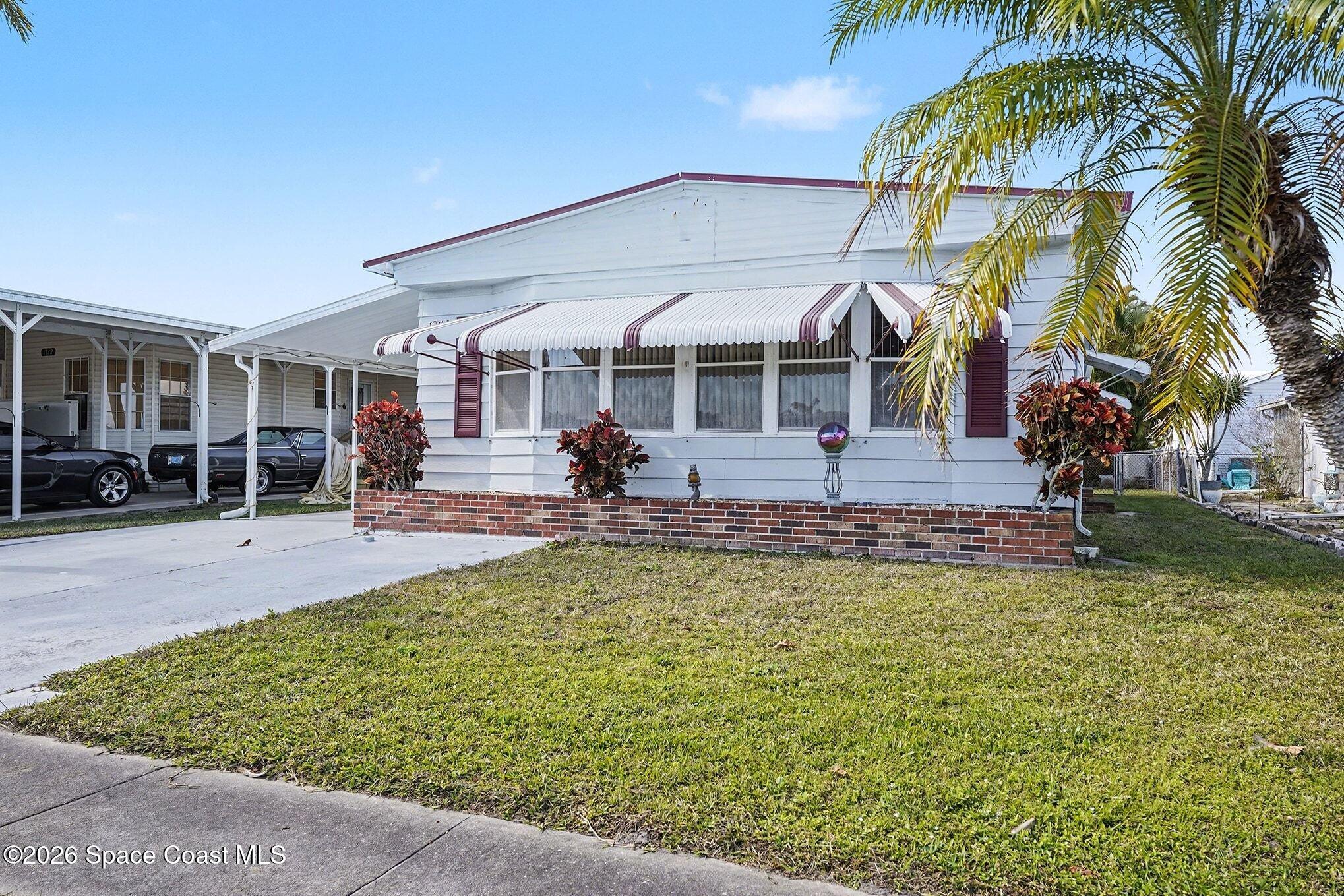 1740 Coco Plum Street Northeast Palm Bay, FL 32905 - Photo 2 of 33 a view of a house with swimming pool and sitting area