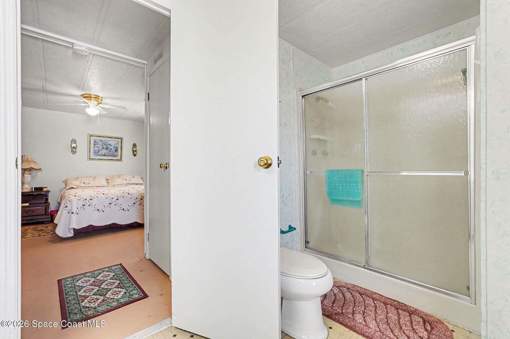 1740 Coco Plum Street Northeast Palm Bay, FL 32905 - Photo 23 of 33 a bathroom with a toilet and a shower
