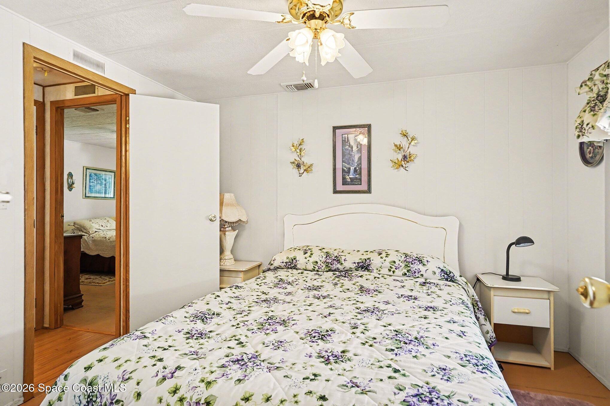 1740 Coco Plum Street Northeast Palm Bay, FL 32905 - Photo 24 of 33 a bedroom with a bed and a dresser