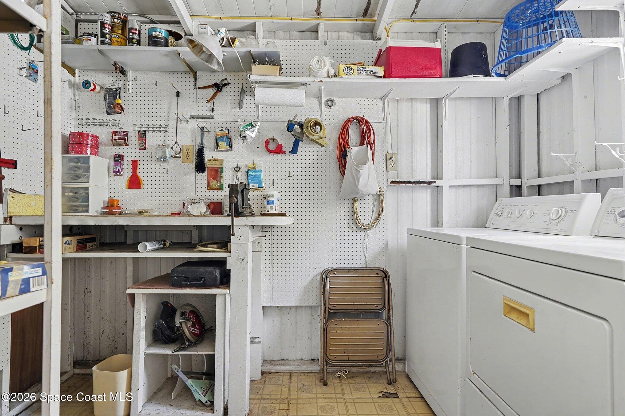 1740 Coco Plum Street Northeast Palm Bay, FL 32905 - Photo 28 of 33 a utility room with multiple dryer and washer