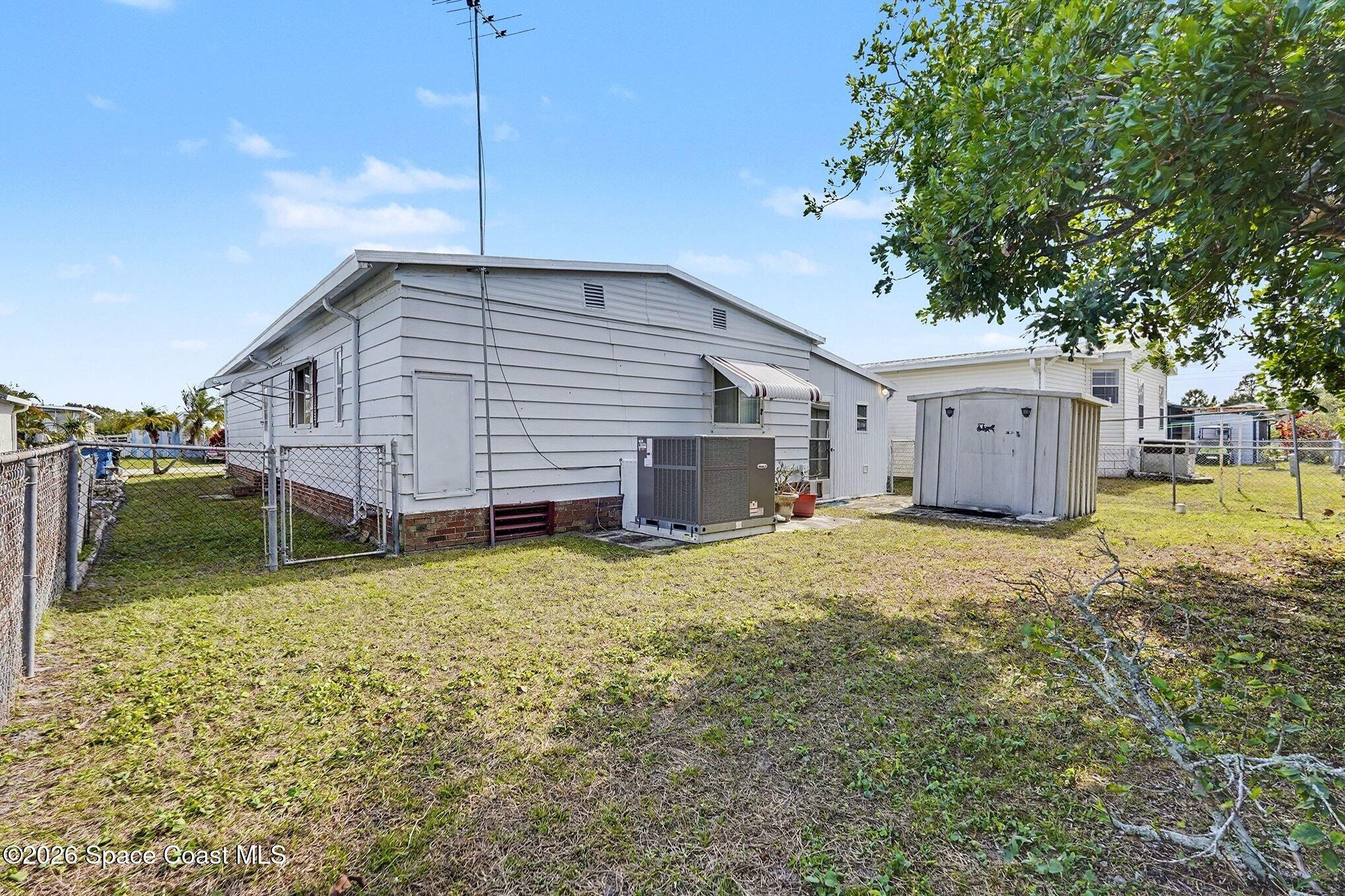 1740 Coco Plum Street Northeast Palm Bay, FL 32905 - Photo 29 of 33 a view of a house with a backyard
