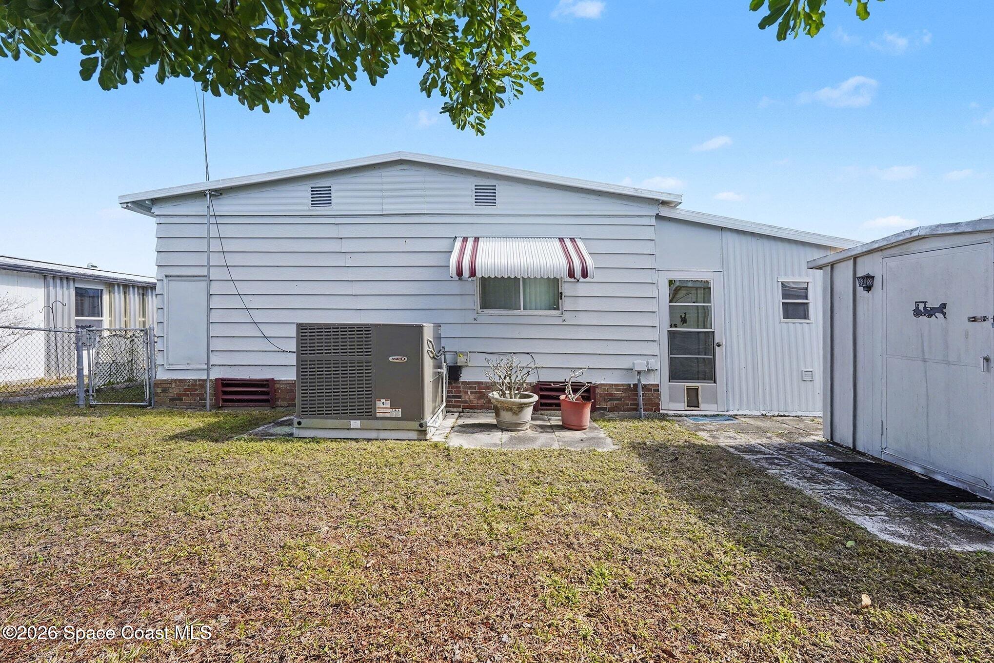 1740 Coco Plum Street Northeast Palm Bay, FL 32905 - Photo 30 of 33 a front view of a house with garden