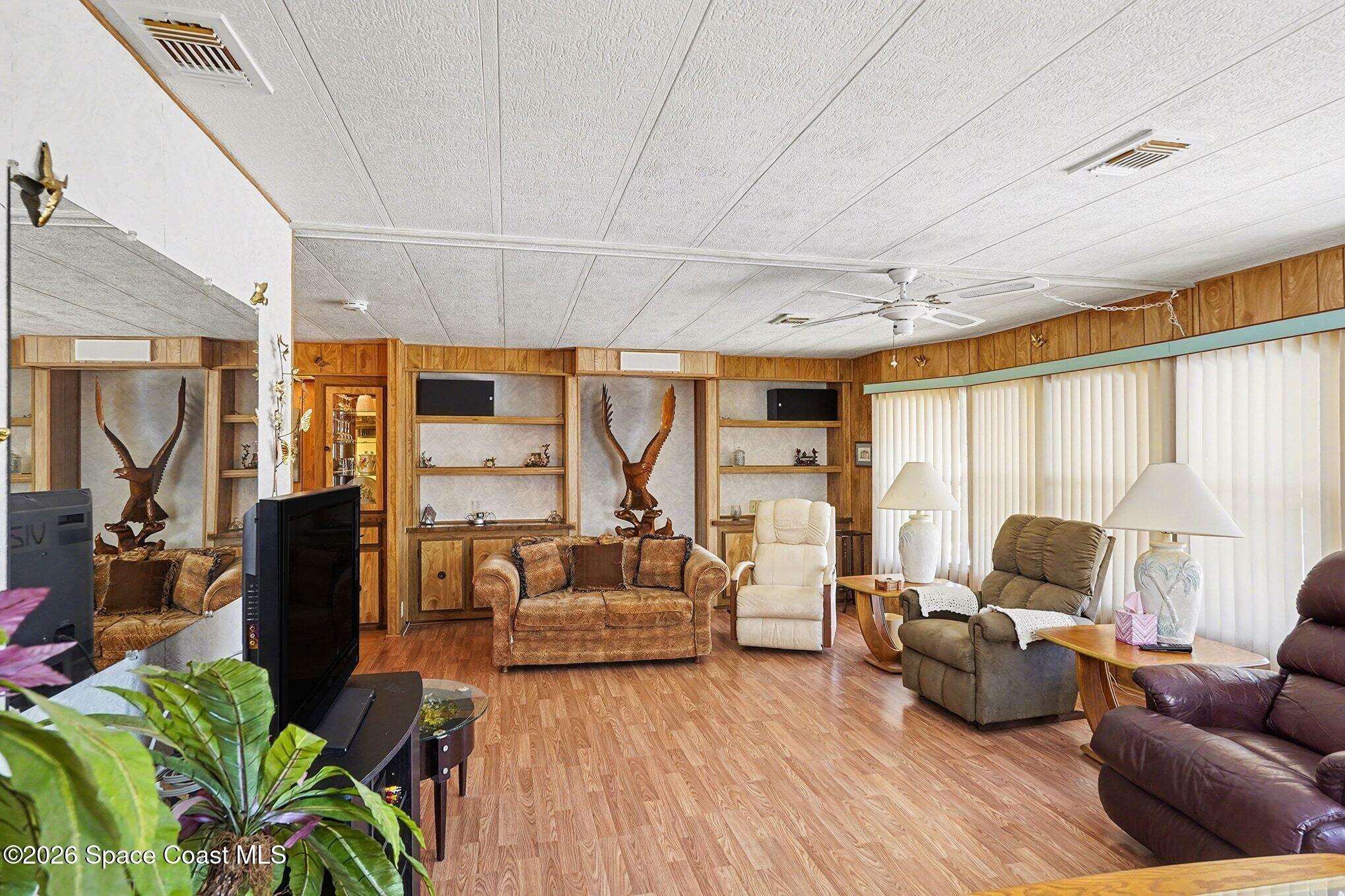 1740 Coco Plum Street Northeast Palm Bay, FL 32905 - Photo 3 of 33 a living room with furniture and a large window