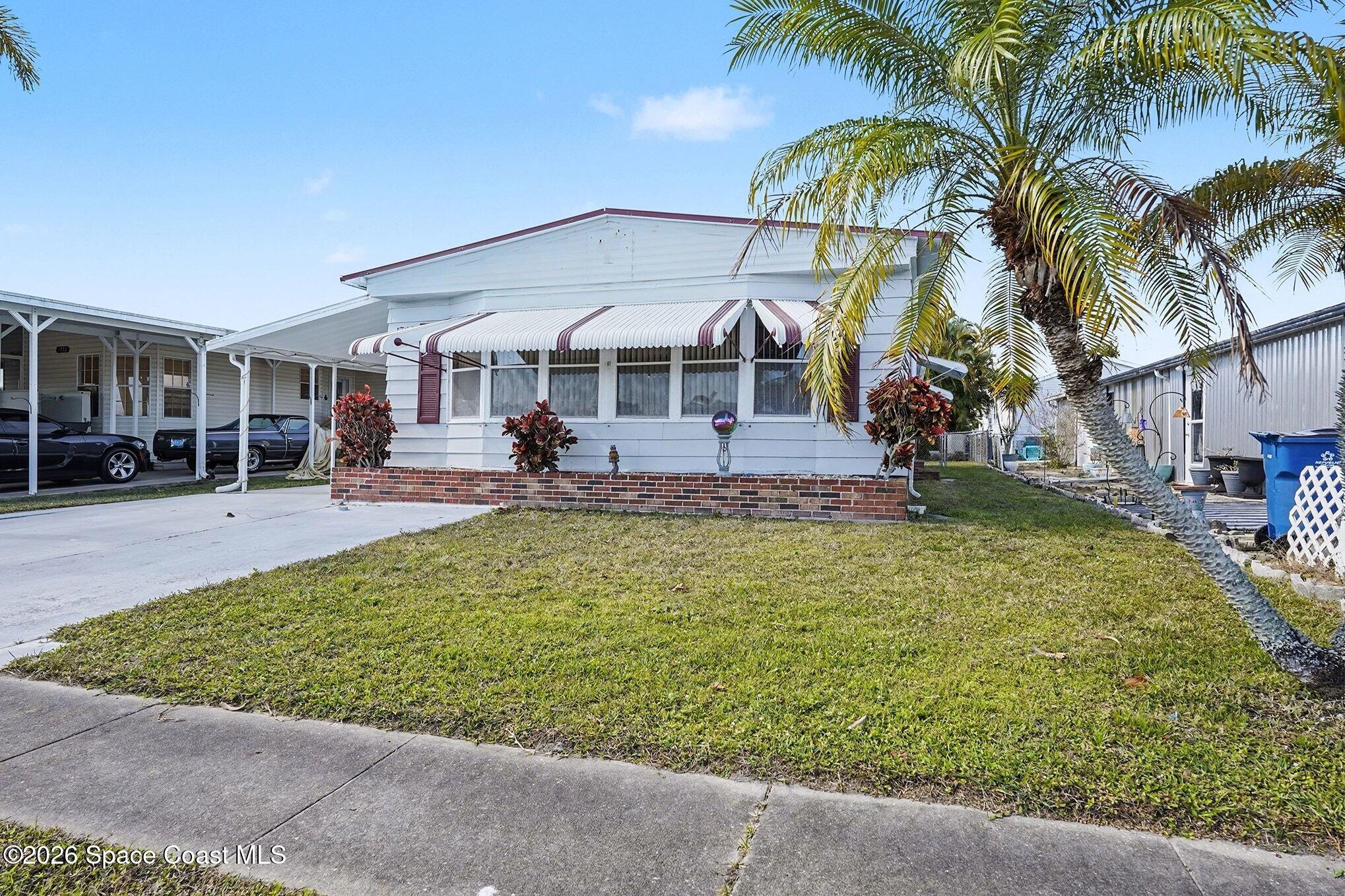 1740 Coco Plum Street Northeast Palm Bay, FL 32905 - Photo 33 of 33 a front view of a house with garden
