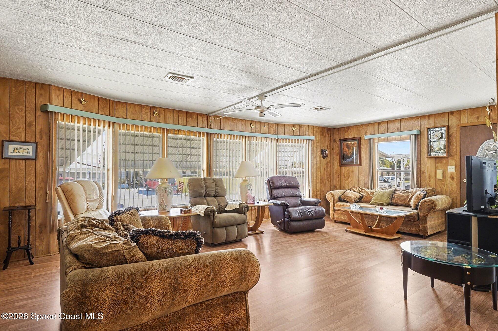 1740 Coco Plum Street Northeast Palm Bay, FL 32905 - Photo 4 of 33 a living room with furniture and a large window