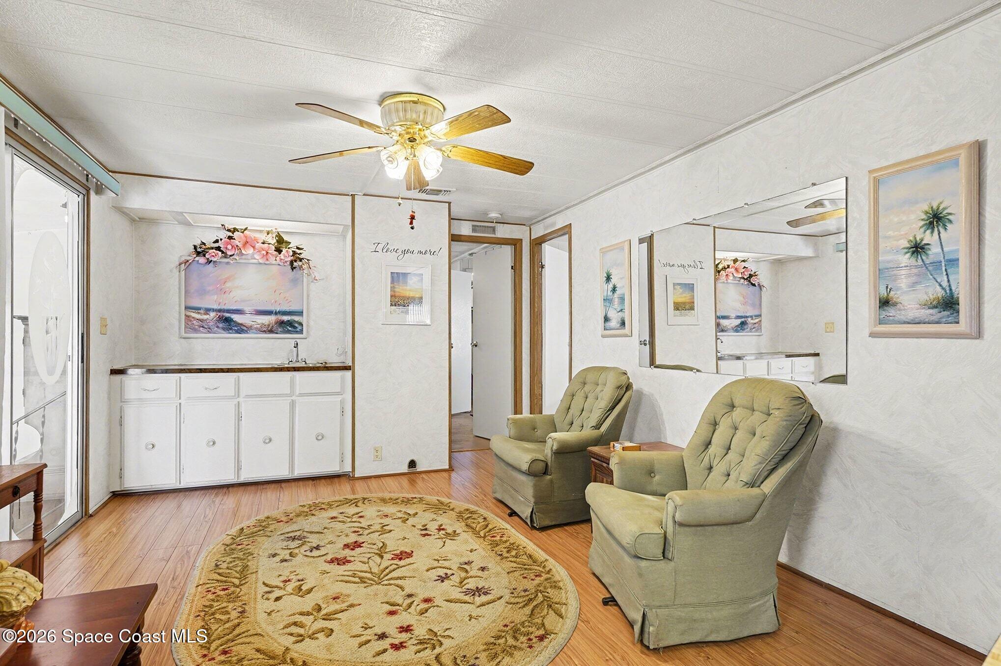 1740 Coco Plum Street Northeast Palm Bay, FL 32905 - Photo 10 of 33 a living room with furniture and a rug