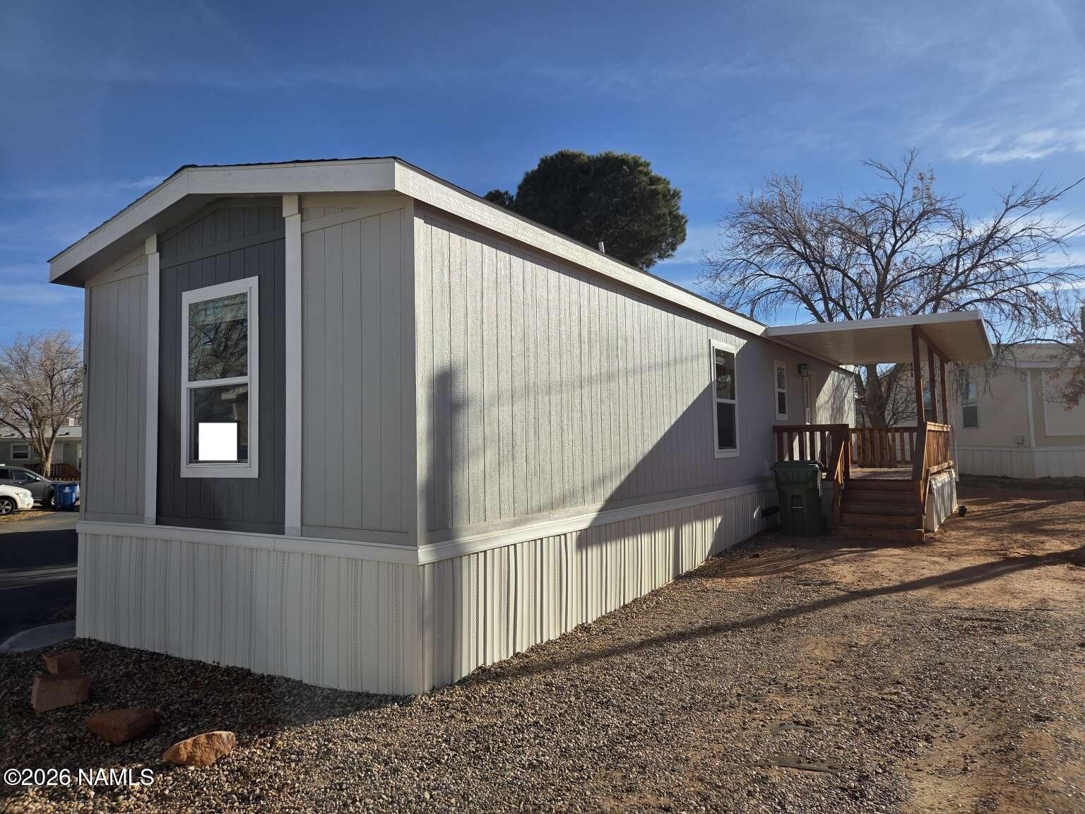 801 Oak Street, Unit 62 Page, AZ 86040 - Photo 2 of 5 a front view of a house with wooden fence