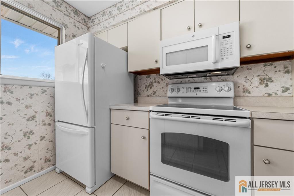 460A Delair Road, Unit A Monroe Township, NJ 08831 - Photo 12 of 29 a kitchen with stainless steel appliances white cabinets and a refrigerator