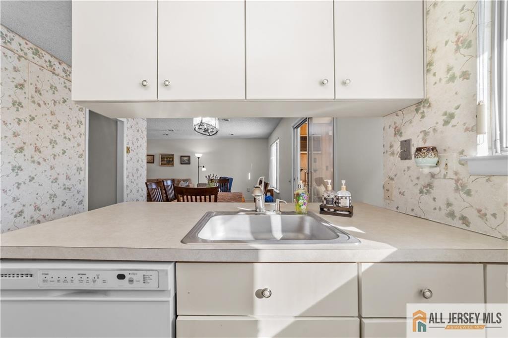 460A Delair Road, Unit A Monroe Township, NJ 08831 - Photo 13 of 29 a kitchen with stainless steel appliances granite countertop a sink a stove and white cabinets