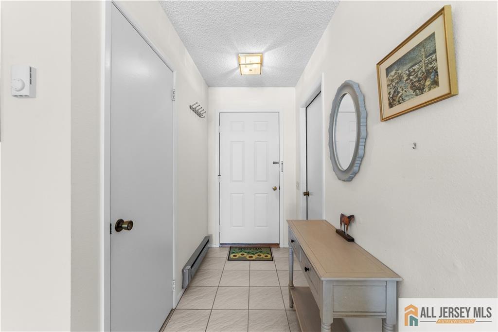 460A Delair Road, Unit A Monroe Township, NJ 08831 - Photo 4 of 29 a room with painting and a table