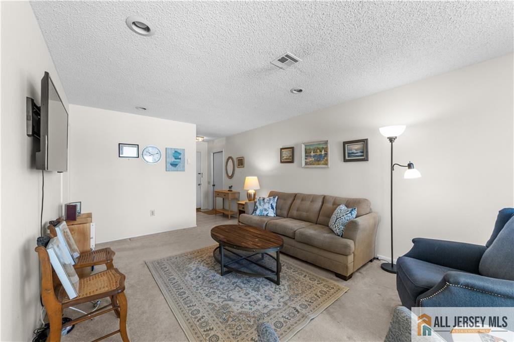 460A Delair Road, Unit A Monroe Township, NJ 08831 - Photo 6 of 29 a living room with furniture and a flat screen tv