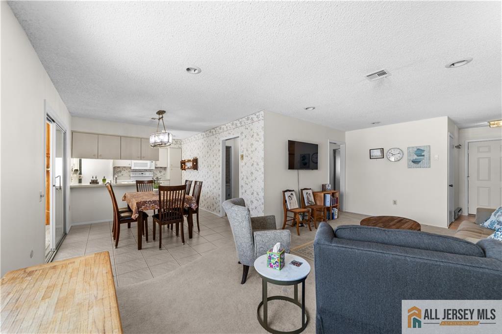 460A Delair Road, Unit A Monroe Township, NJ 08831 - Photo 7 of 29 a view of a dining room with furniture and wooden floor