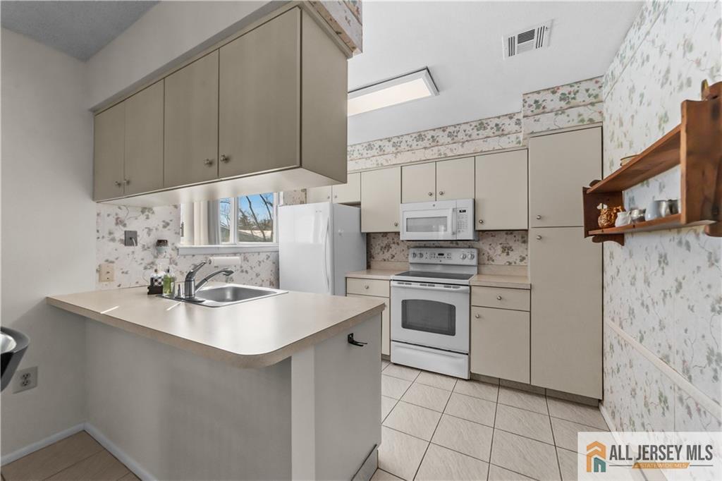 460A Delair Road, Unit A Monroe Township, NJ 08831 - Photo 10 of 29 a kitchen with stainless steel appliances a stove refrigerator sink and cabinets