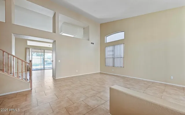 a view of an empty room with glass door