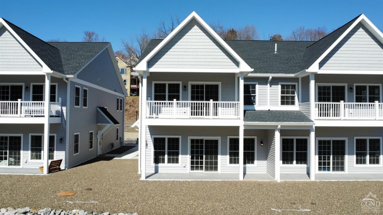 29 Marina Drive Catskill, NY 12414 - Photo 27 of 28 a view of a white house with large windows and a small yard