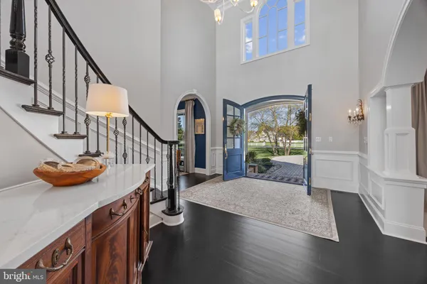 a view of entryway and hall with wooden floor