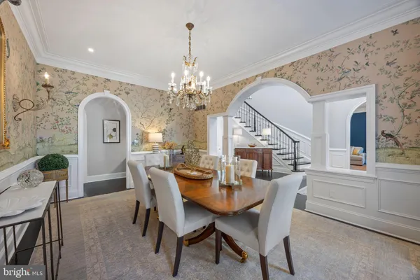 a view of a dining room with furniture and chandelier
