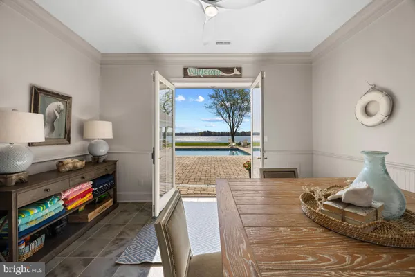 a living room with stainless steel appliances kitchen island granite countertop a refrigerator and a sink