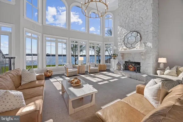 a living room with fireplace furniture and a large window