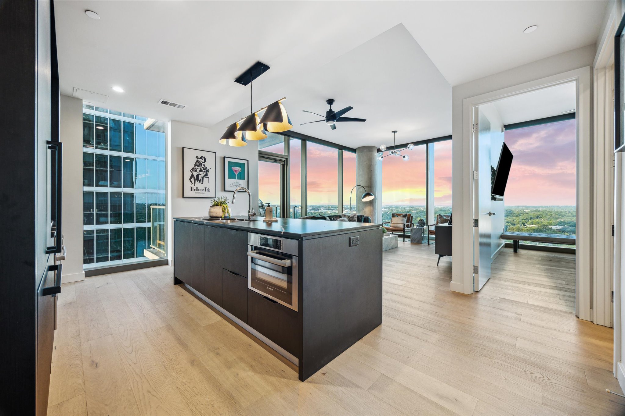 44 East Avenue, Unit 1607 Austin, TX 78701 - Photo 4 of 19 a living room with stainless steel appliances kitchen island granite countertop a refrigerator a stove and a view of living room