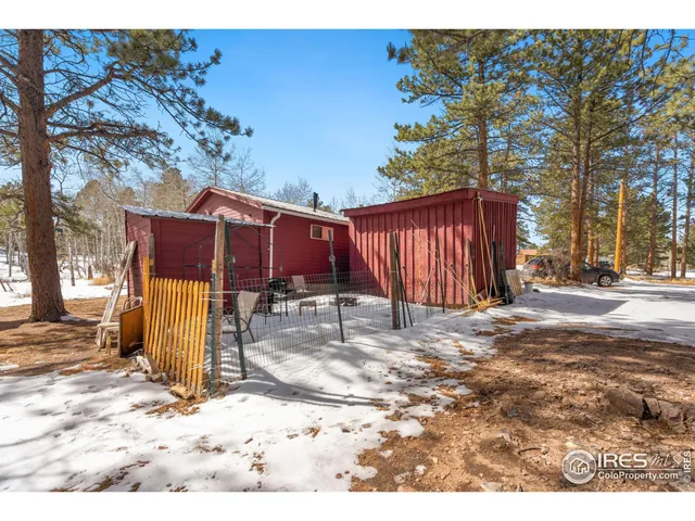 a view of a backyard with wooden fence