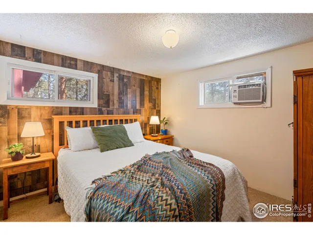 a bedroom with a bed and a painting on the wall