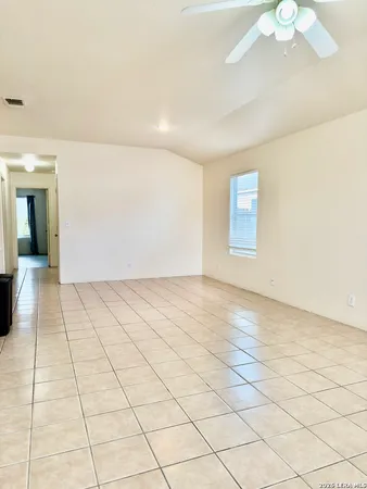 a view of an empty room and a window