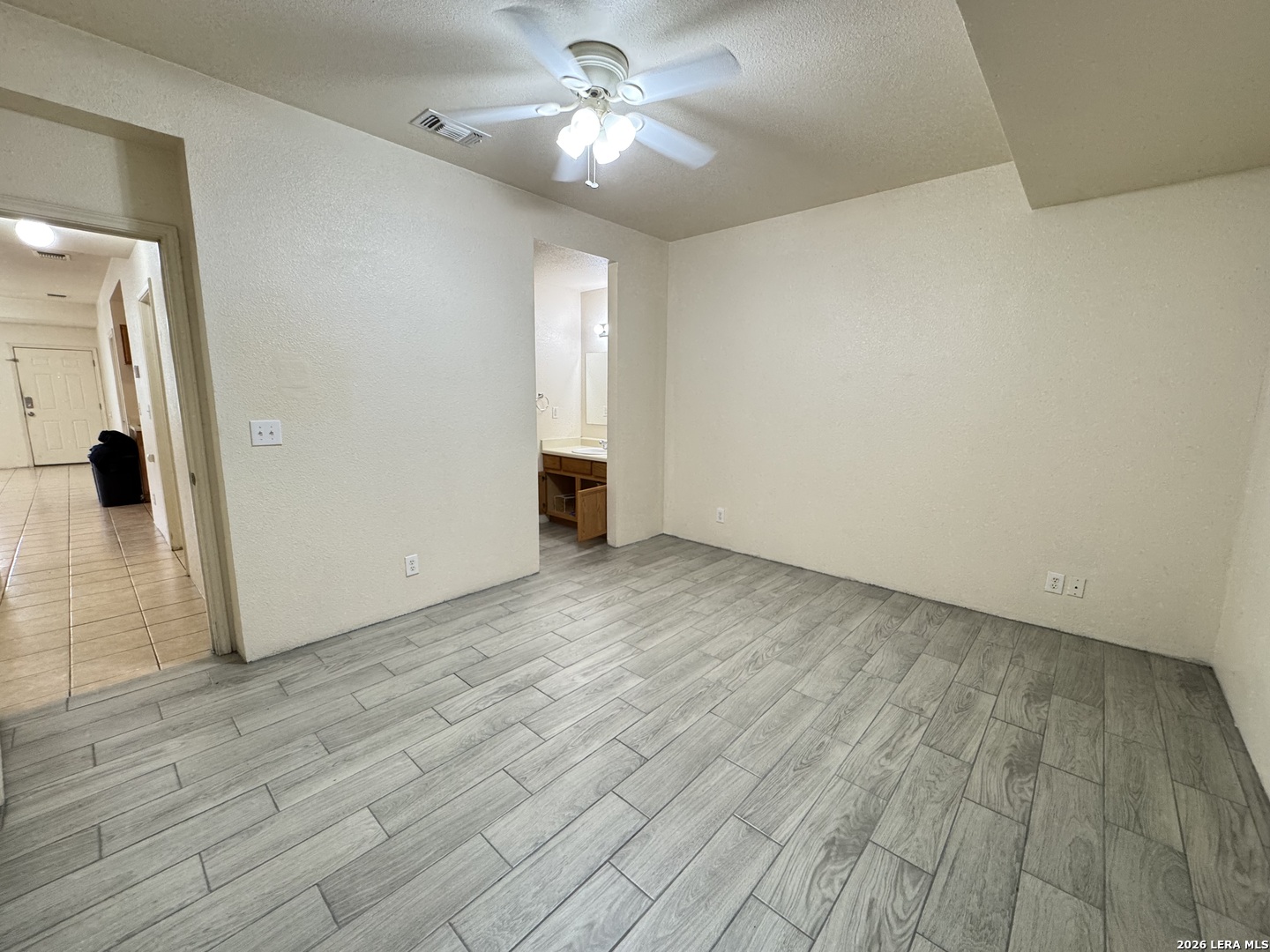 7921 M G Road San Antonio, TX 78251 - Photo 6 of 10 a view of empty room with wooden floor and fan