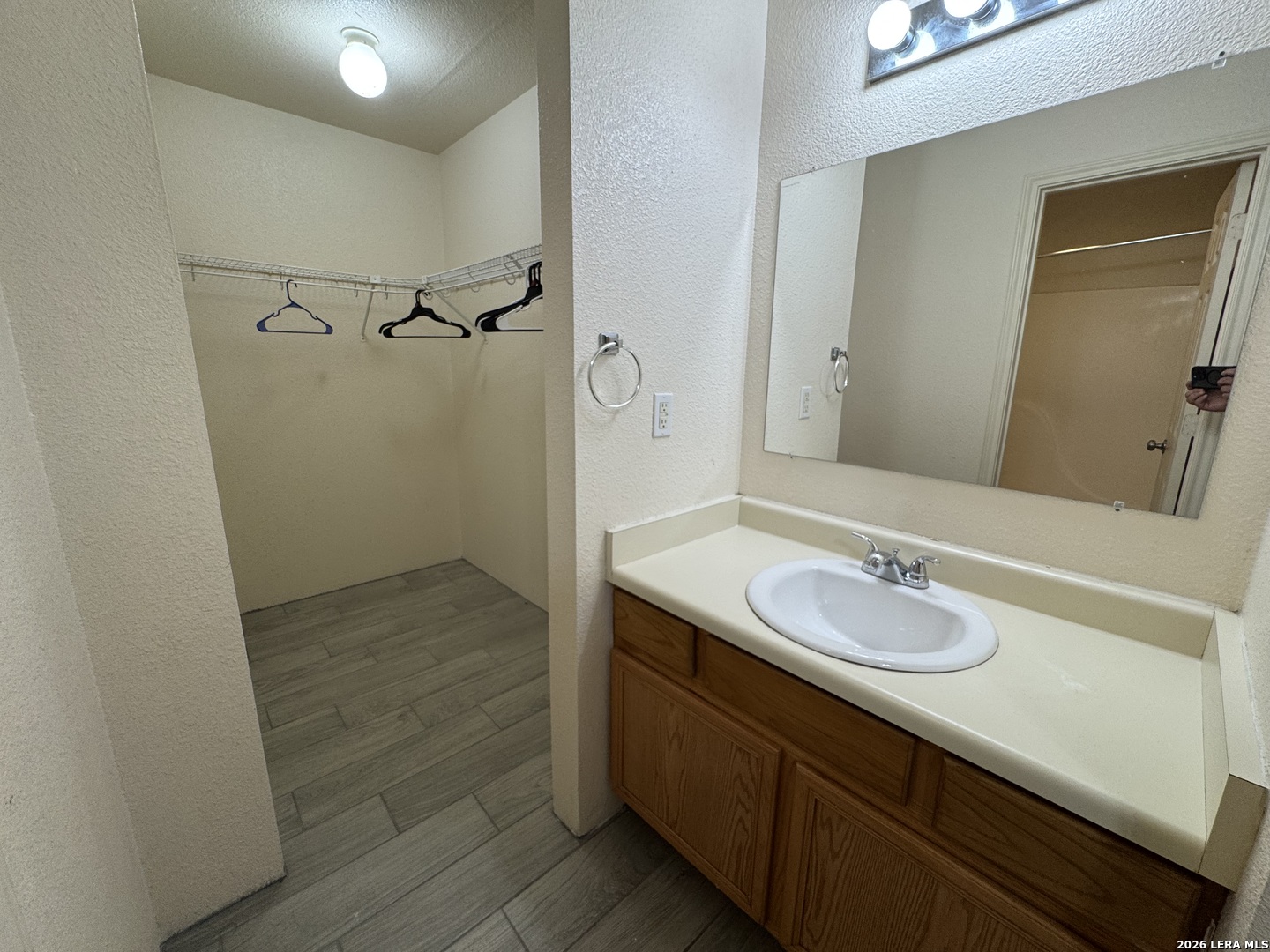 7921 M G Road San Antonio, TX 78251 - Photo 8 of 10 a bathroom with a granite countertop sink a mirror and shower