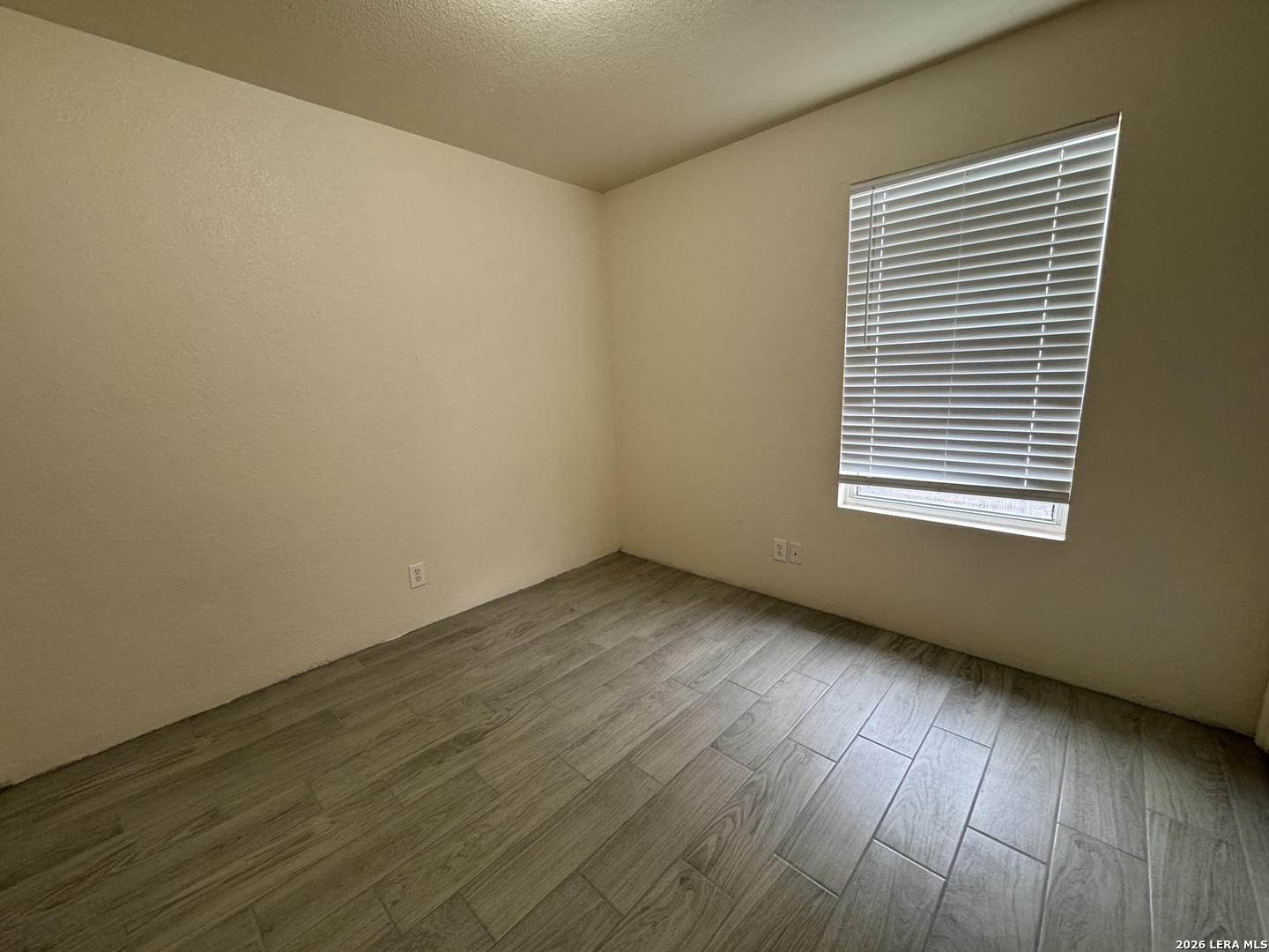7921 M G Road San Antonio, TX 78251 - Photo 9 of 10 an empty room with wooden floor and windows
