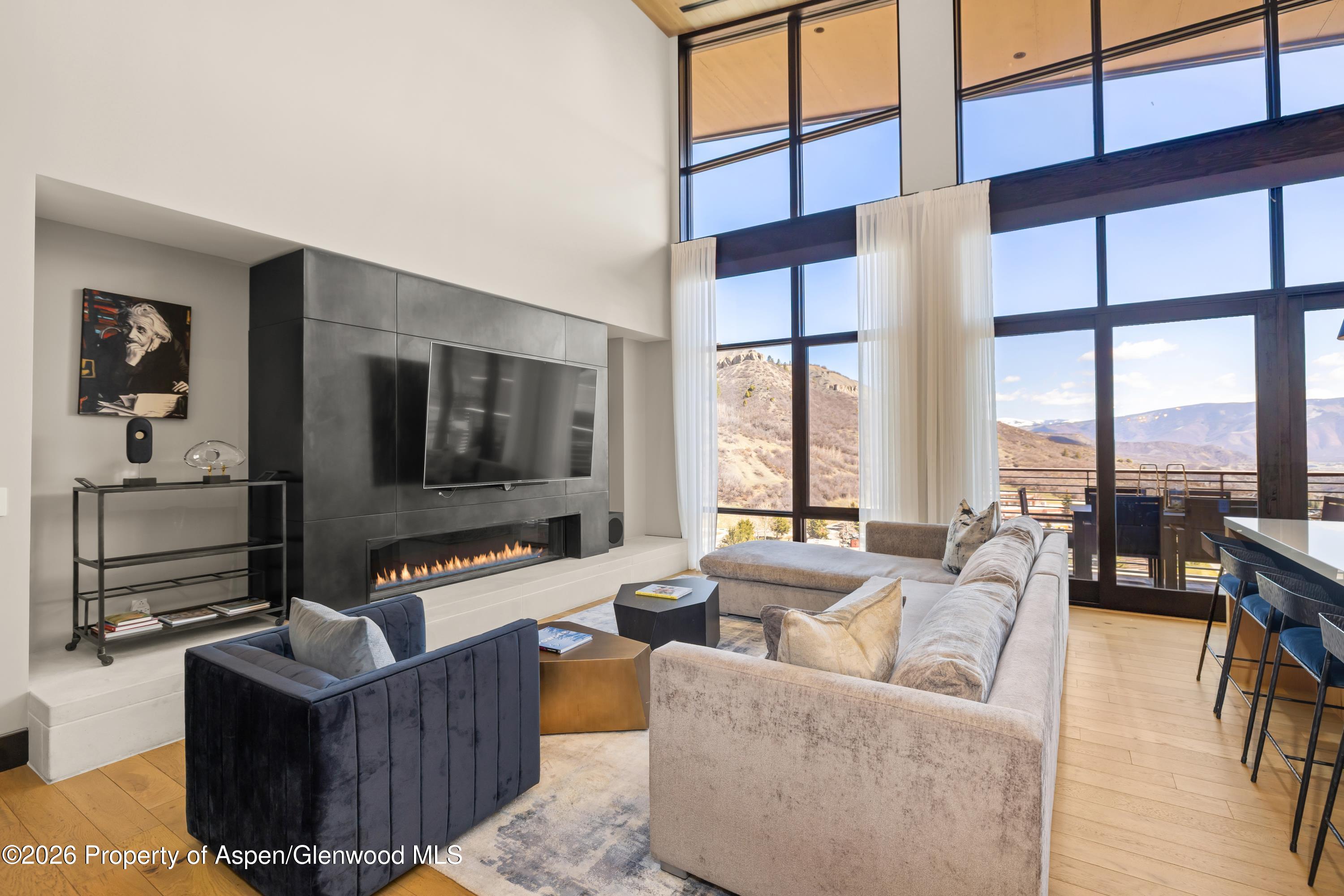 77 Wood Road, Unit 703 EAST Snowmass Village, CO 81615 - Photo 1 of 21 a living room with furniture and a flat screen tv