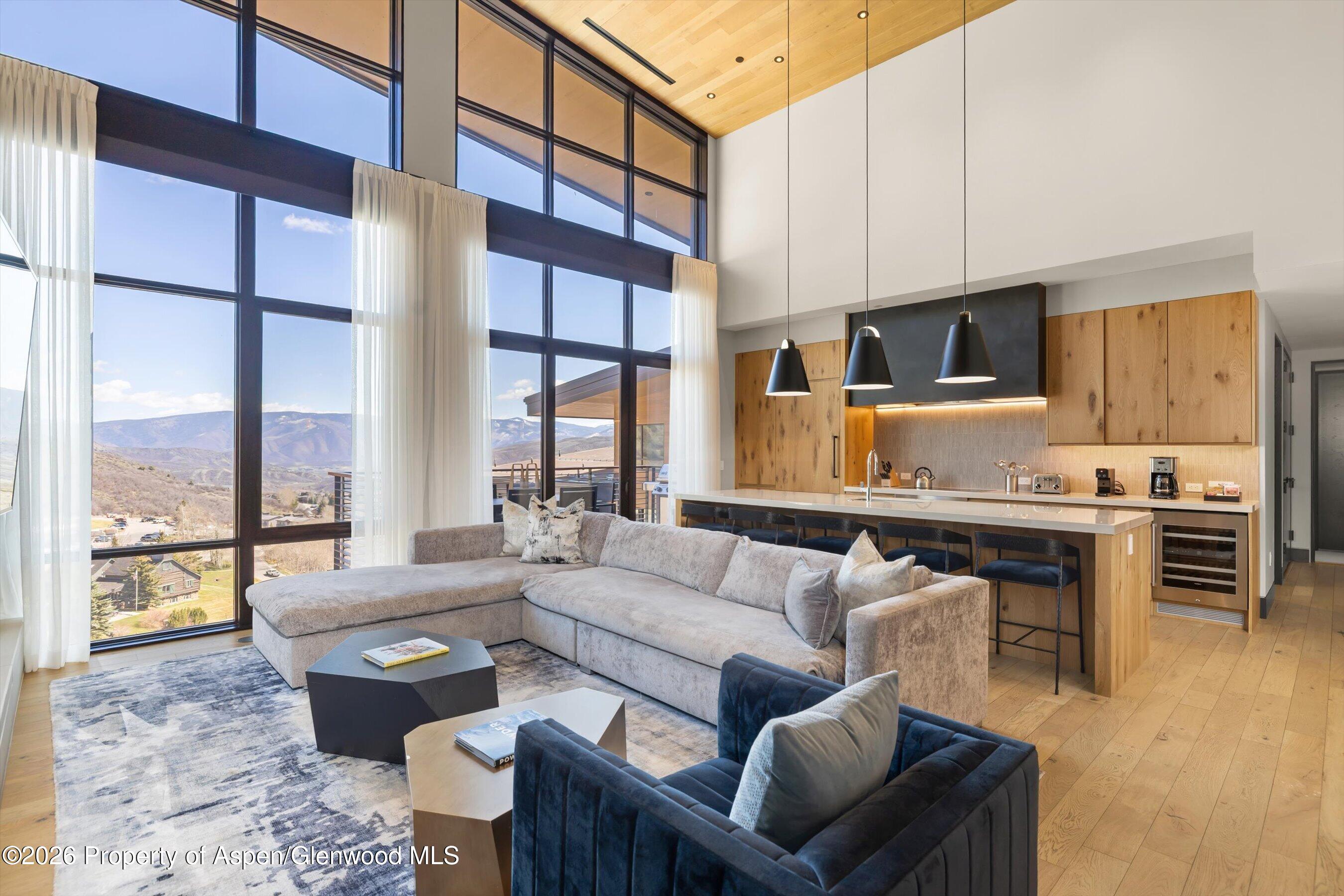 77 Wood Road, Unit 703 EAST Snowmass Village, CO 81615 - Photo 3 of 21 a living room with furniture and a large window