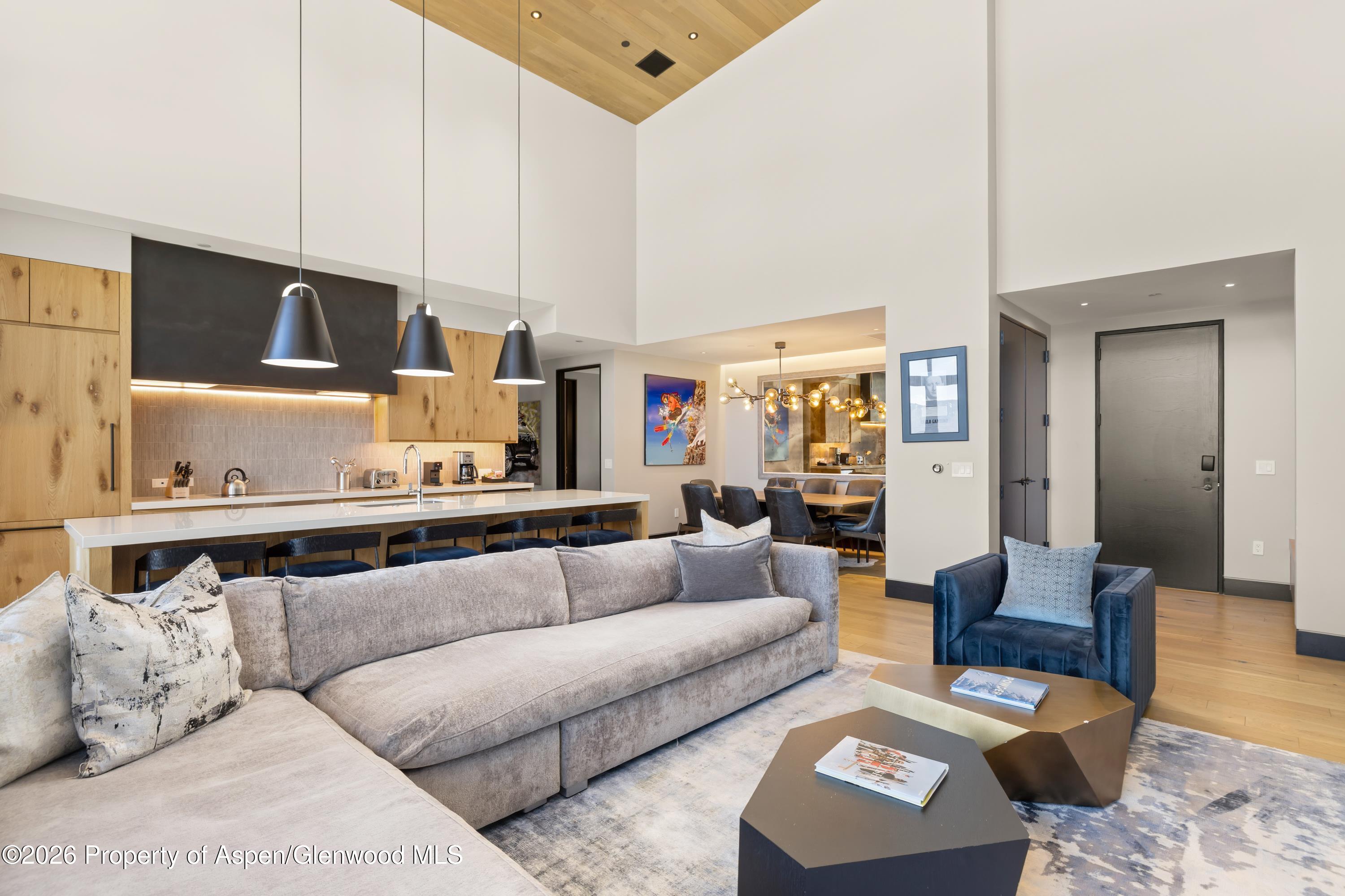 77 Wood Road, Unit 703 EAST Snowmass Village, CO 81615 - Photo 5 of 21 a living room with furniture and kitchen view