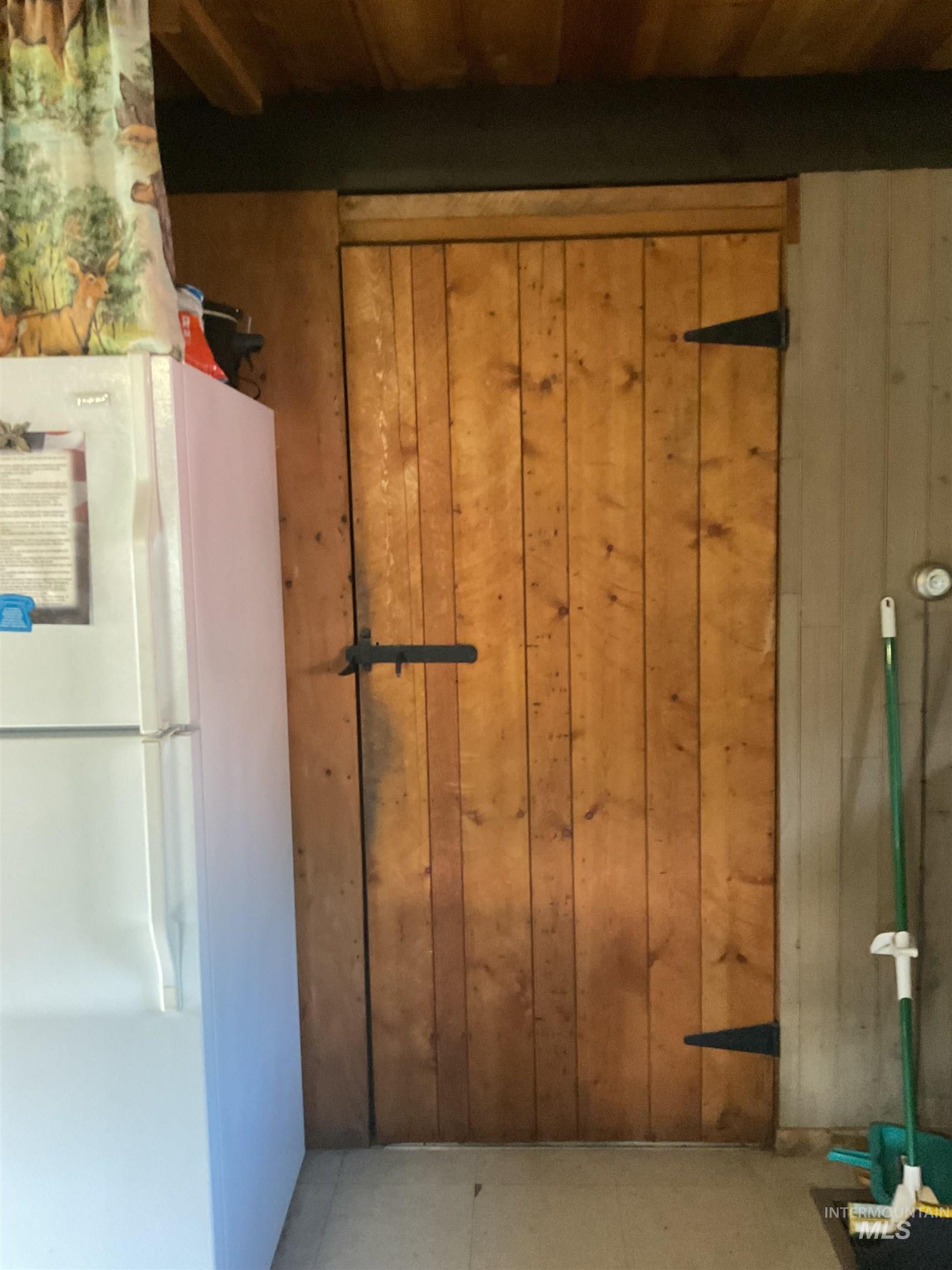 2871 Orogrande-Dixie Road Elk City, ID 83525 - Photo 32 of 40 Rustic wooden door featuring black metal strap hinges and a coordinating latch