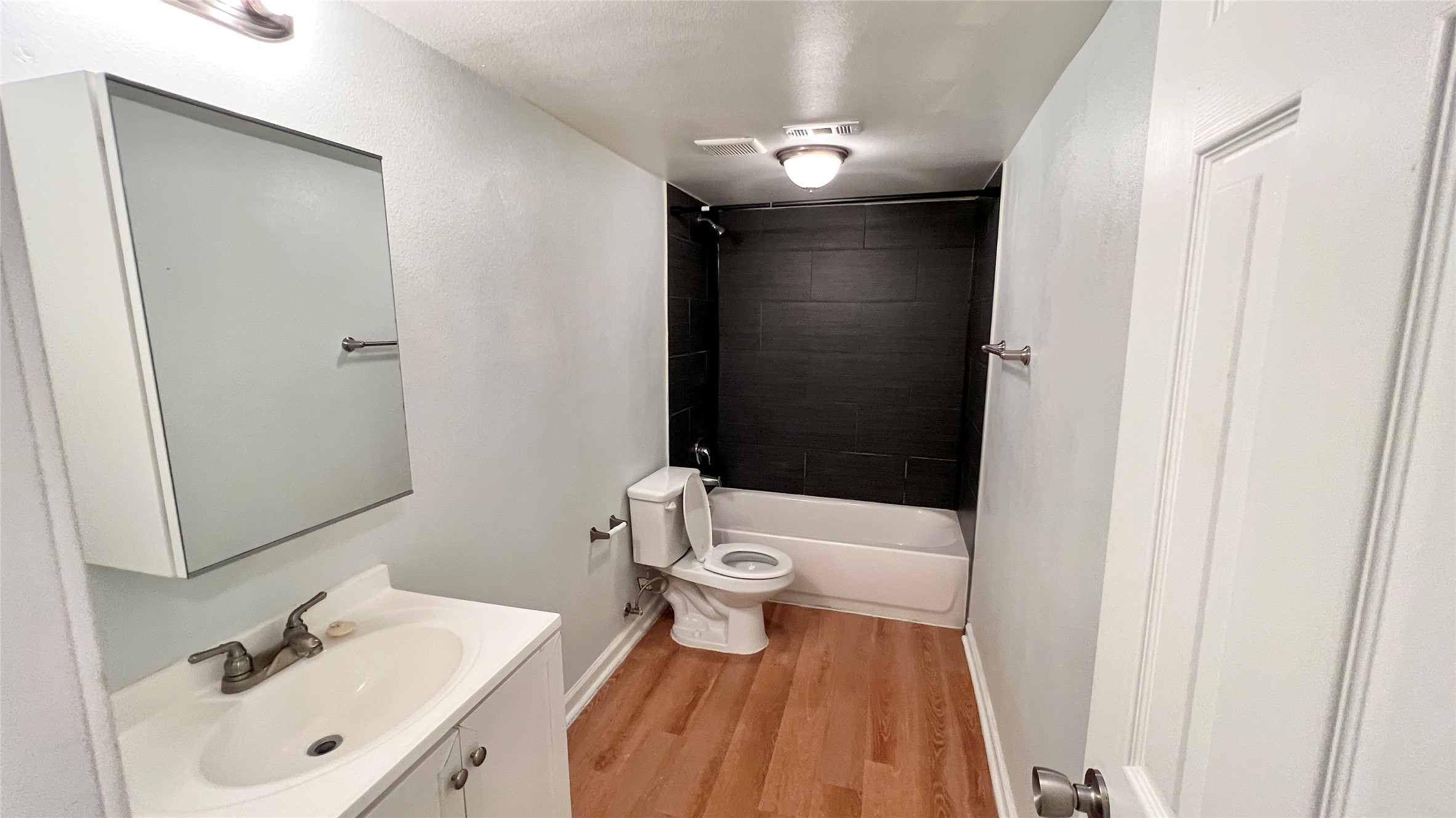 2301 Ohlen Road, Unit 107 Austin, TX 78757 - Photo 5 of 8 Full bath featuring vanity, bathing tub / shower combination, and light wood finished floors