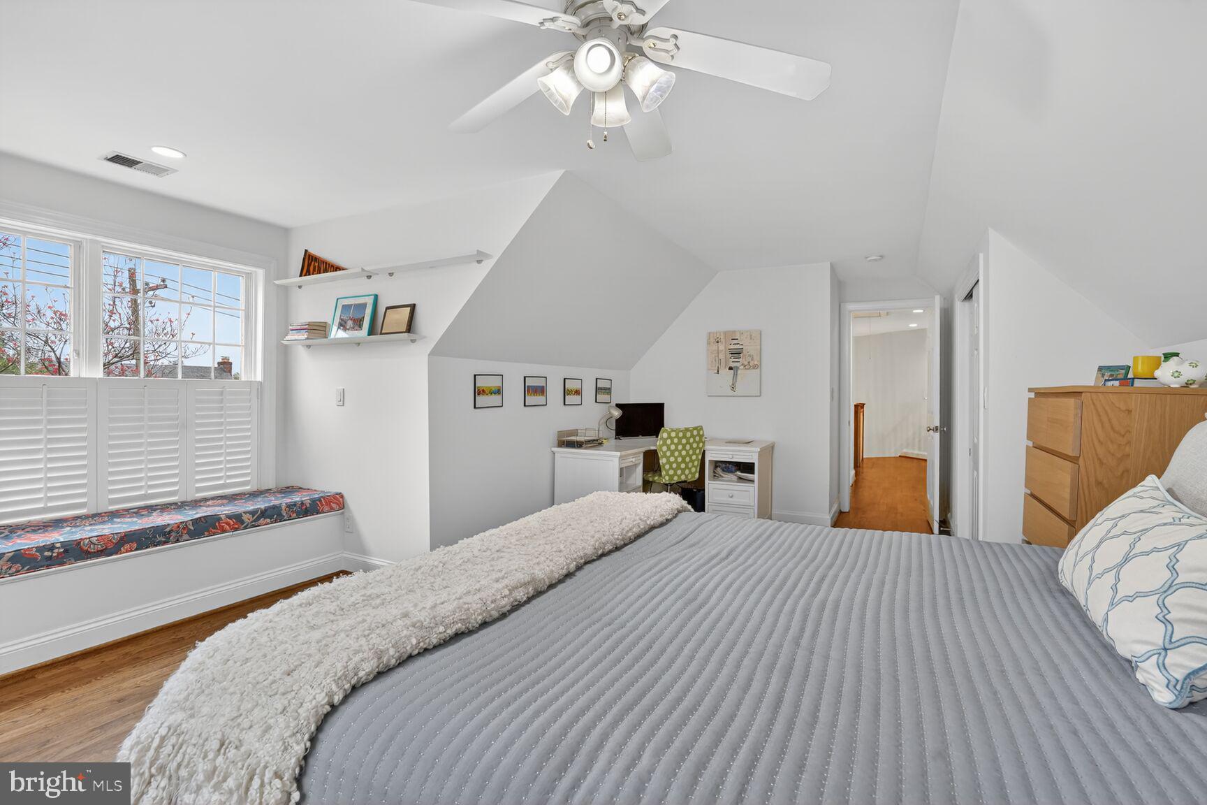 4837 W Street Northwest Washington, DC 20007 - Photo 37 of 51 a bedroom with a large bed and a chandelier