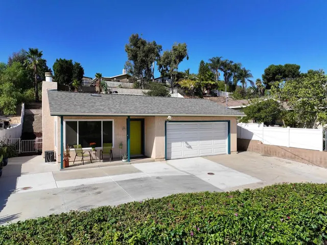 a front view of a house with a porch and a garage